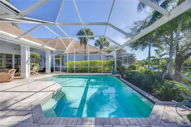 a view of a lake with a house in the background