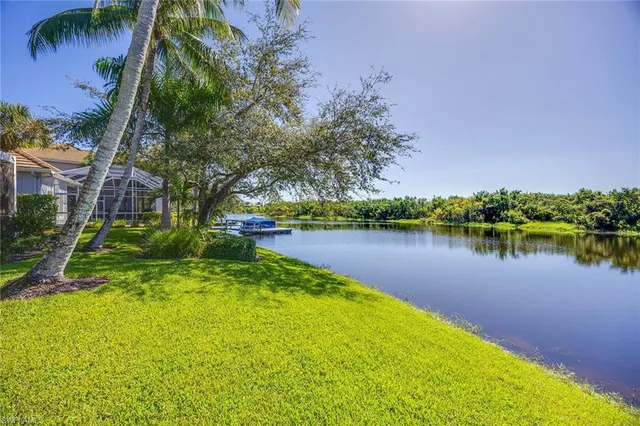 a view of a lake with houses in the back