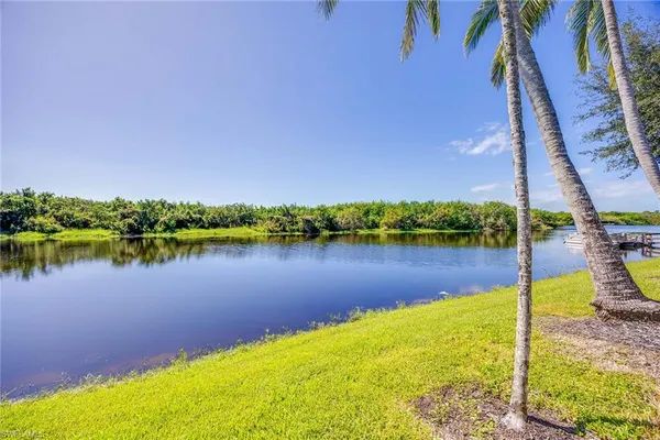 a living room with patio furniture and a floor to ceiling window