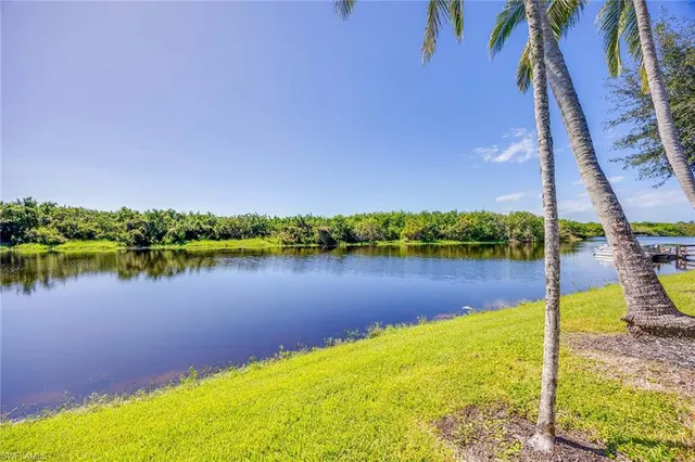 a living room with patio furniture and a floor to ceiling window