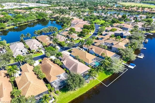an aerial view of a house with a garden and lake view