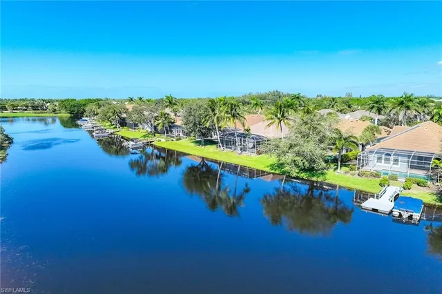 an aerial view of residential houses with outdoor space and ocean view