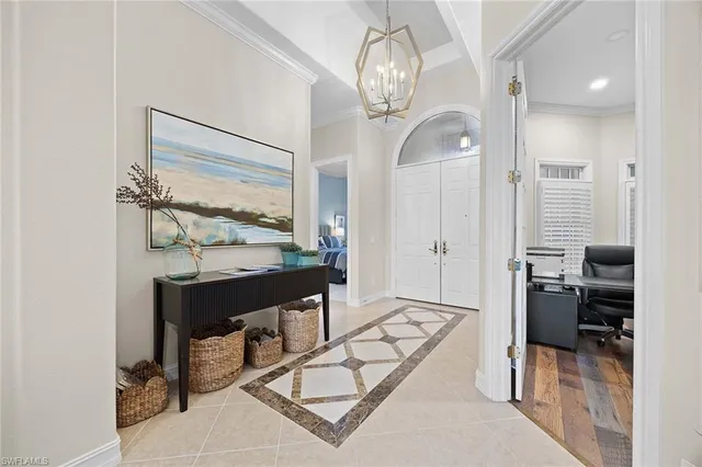 a view of hall way with furniture and chandelier