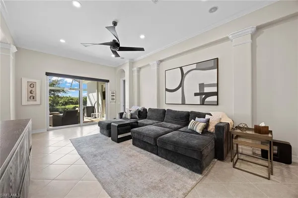 a living room with furniture ceiling fan and a rug