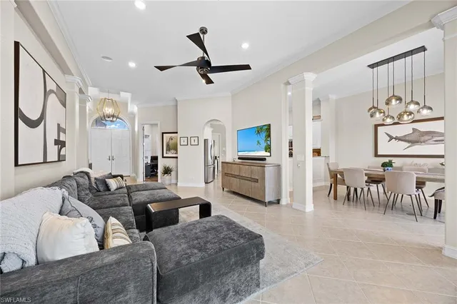 a living room with furniture and kitchen view