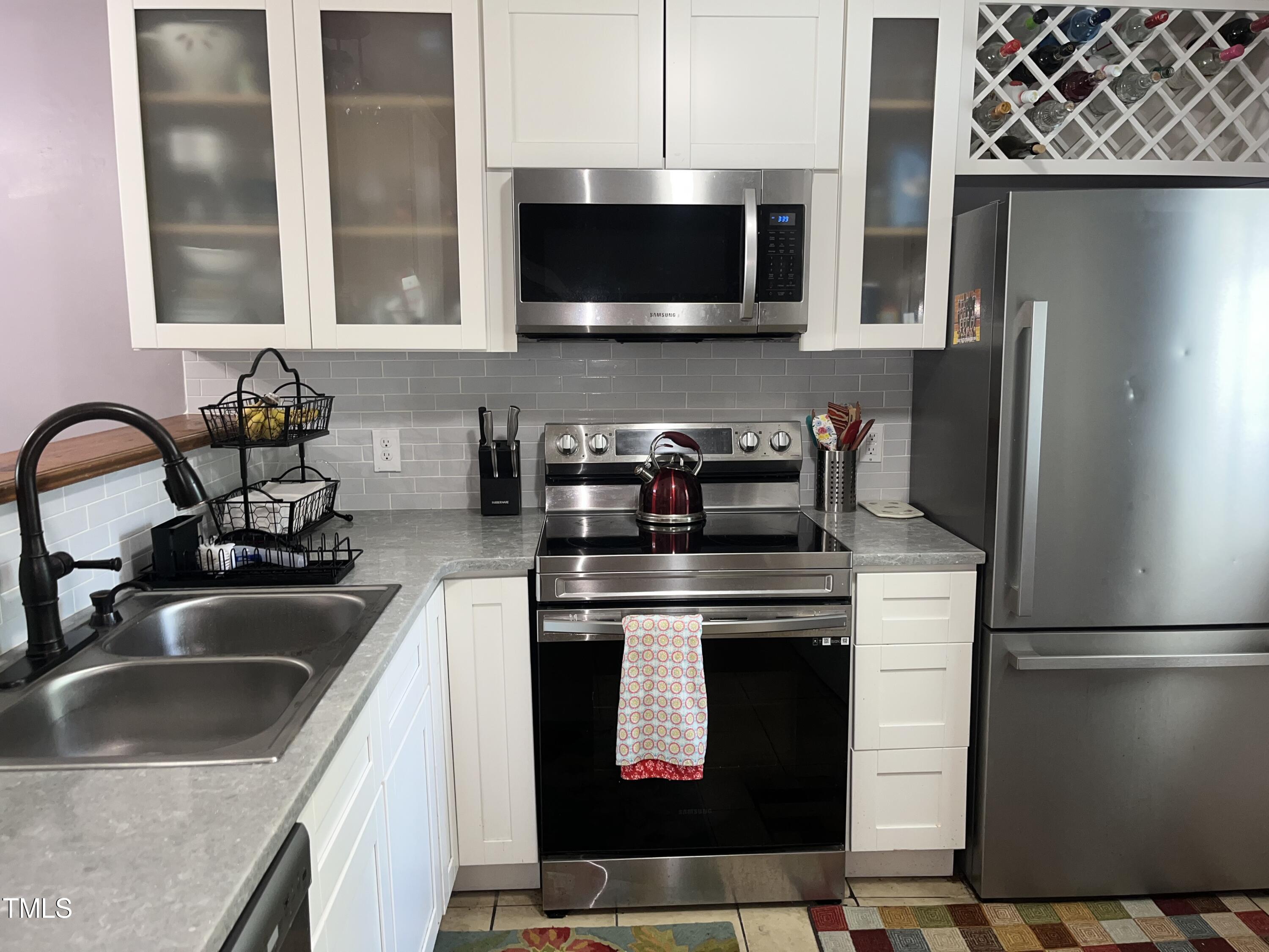 1823 Vintage Road Raleigh, NC 27610 - Photo 2 of 14 a kitchen with stainless steel appliances a stove a sink a microwave and refrigerator
