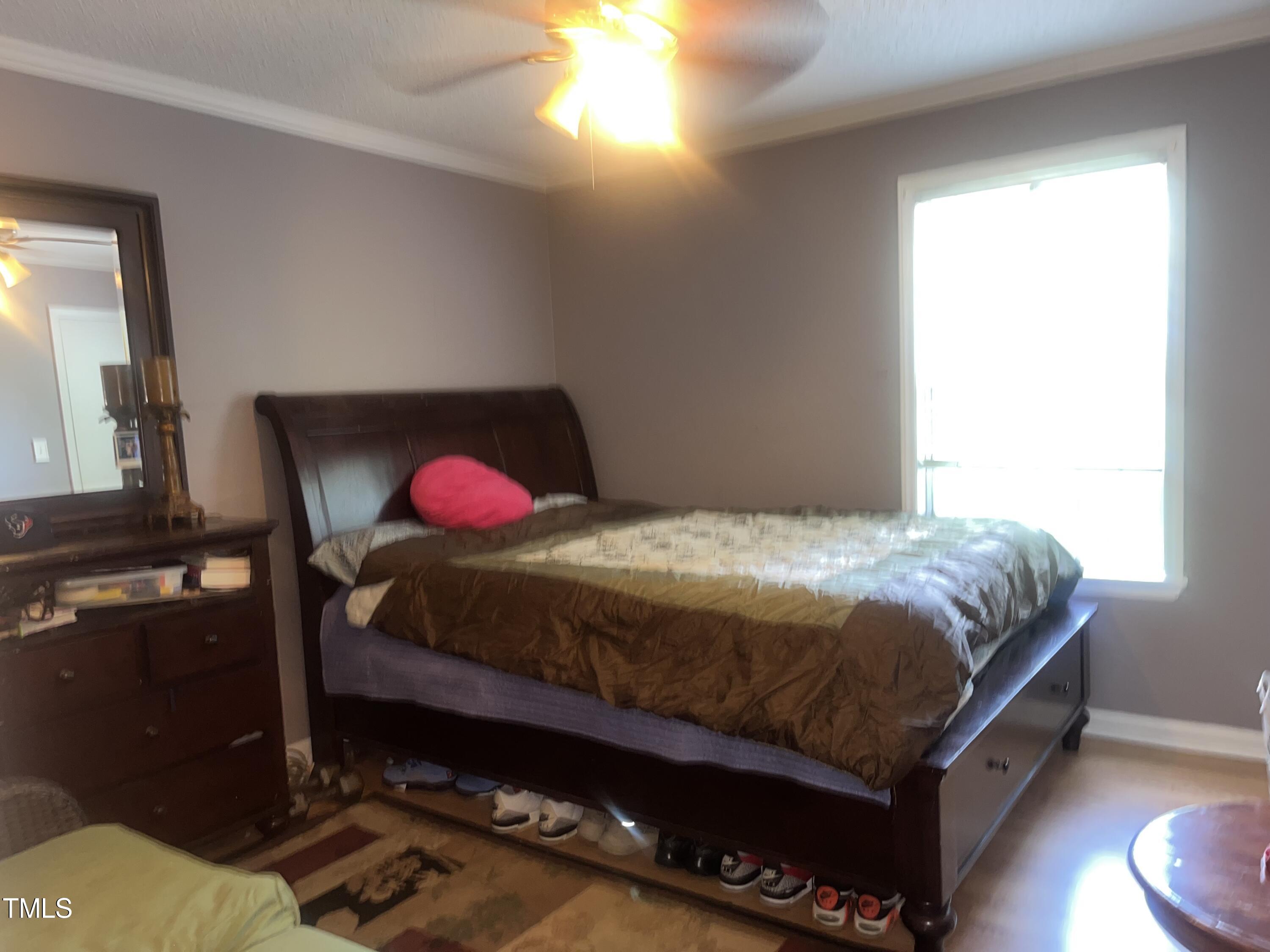 1823 Vintage Road Raleigh, NC 27610 - Photo 4 of 14 a bedroom with a bed and a window