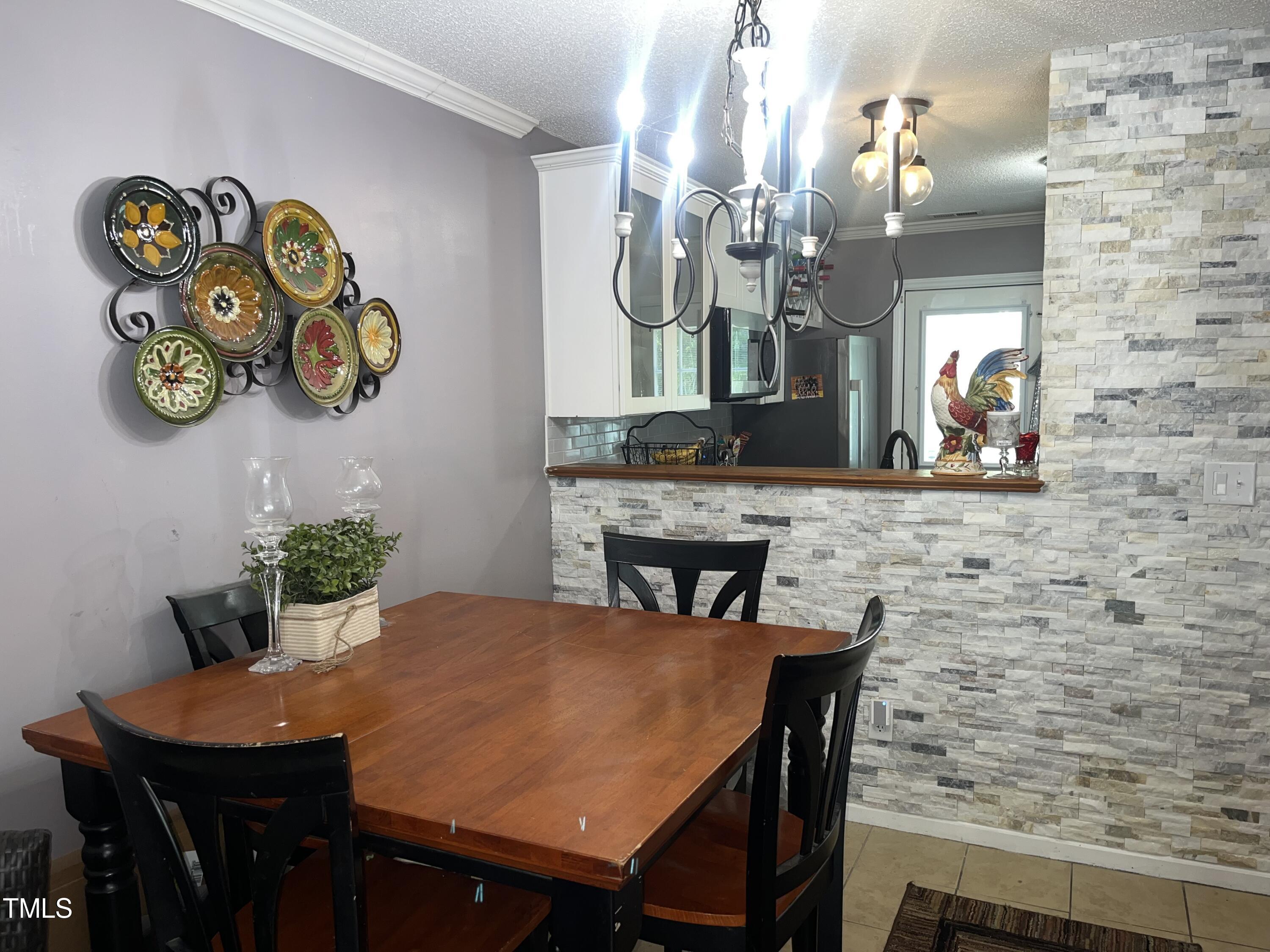 1823 Vintage Road Raleigh, NC 27610 - Photo 7 of 14 a view of a dining room with furniture and chandelier