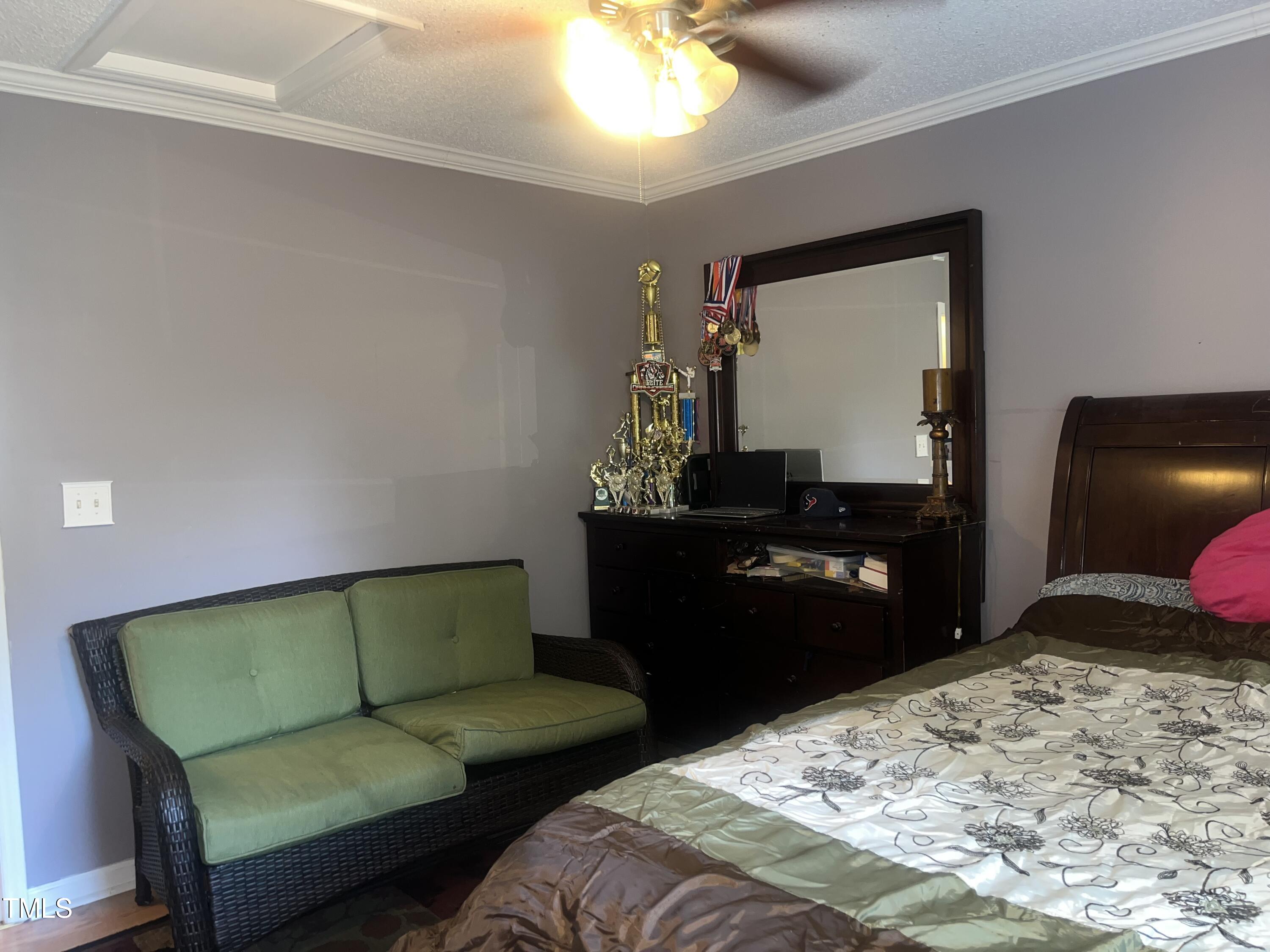 1823 Vintage Road Raleigh, NC 27610 - Photo 9 of 14 a bedroom with a bed and dresser