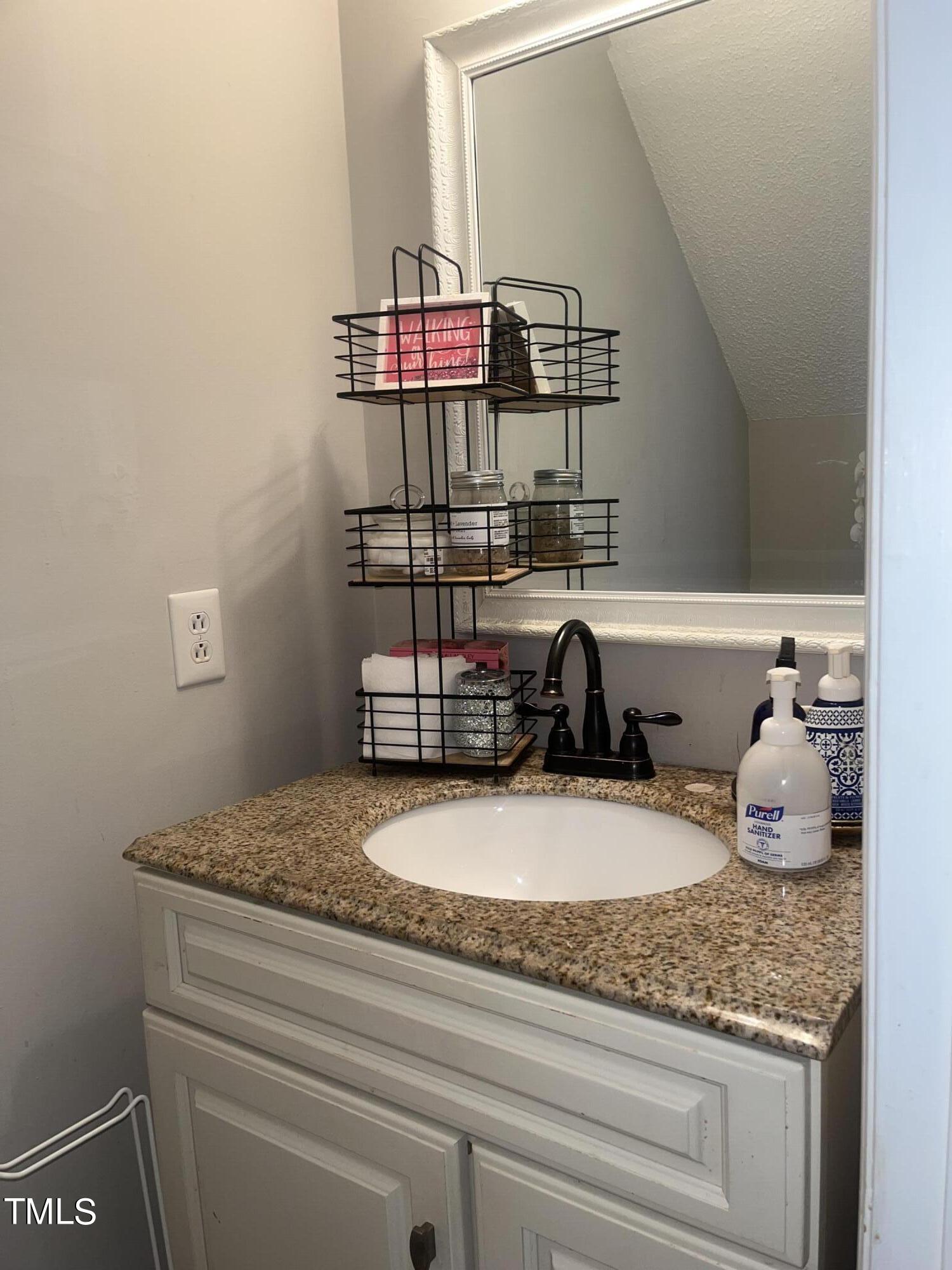 1823 Vintage Road Raleigh, NC 27610 - Photo 10 of 14 a bathroom with a granite countertop sink and a granite counter tops