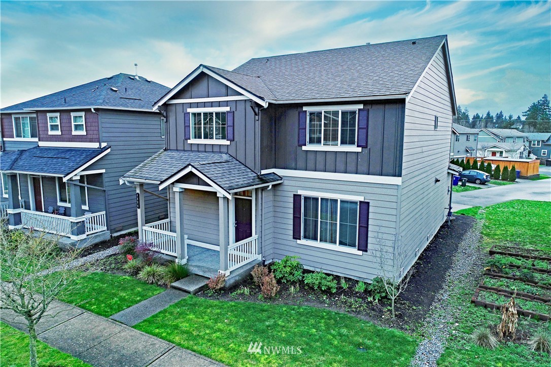 4866 East R Street Tacoma, WA 98404 - Photo 1 of 25 a front view of a house with garden