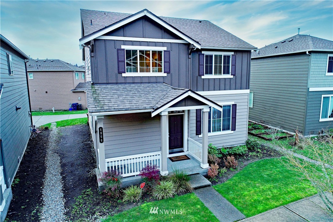 4866 East R Street Tacoma, WA 98404 - Photo 2 of 25 a front view of a house with a garden