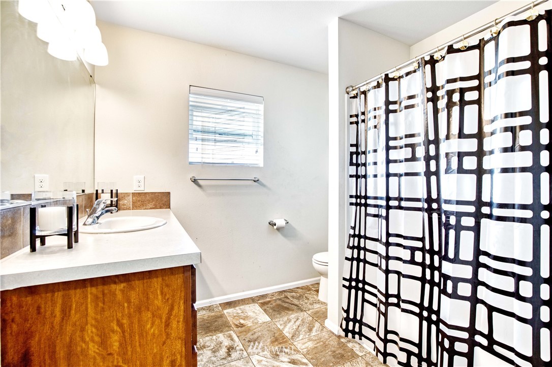 4866 East R Street Tacoma, WA 98404 - Photo 11 of 25 a bathroom with a sink and a bathtub
