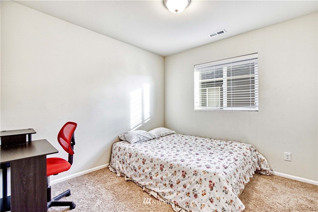 4866 East R Street Tacoma, WA 98404 - Photo 13 of 25 a bedroom with a bed and a window