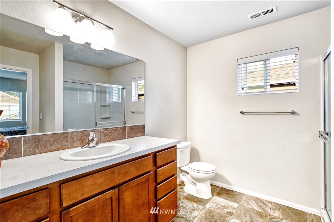 4866 East R Street Tacoma, WA 98404 - Photo 15 of 25 a bathroom with a sink a toilet and shower