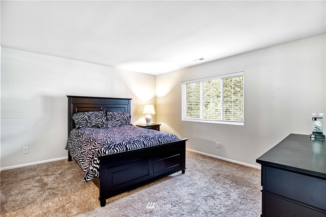 4866 East R Street Tacoma, WA 98404 - Photo 16 of 25 a bedroom with a bed and a window