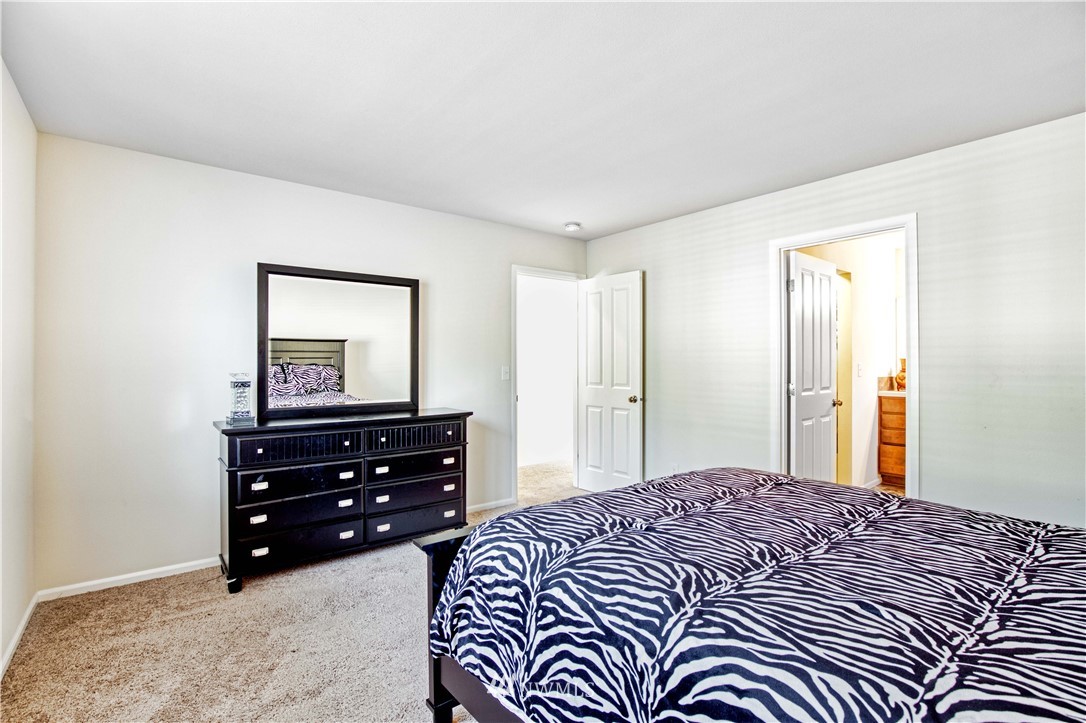 4866 East R Street Tacoma, WA 98404 - Photo 17 of 25 a bedroom with a bed and a dresser