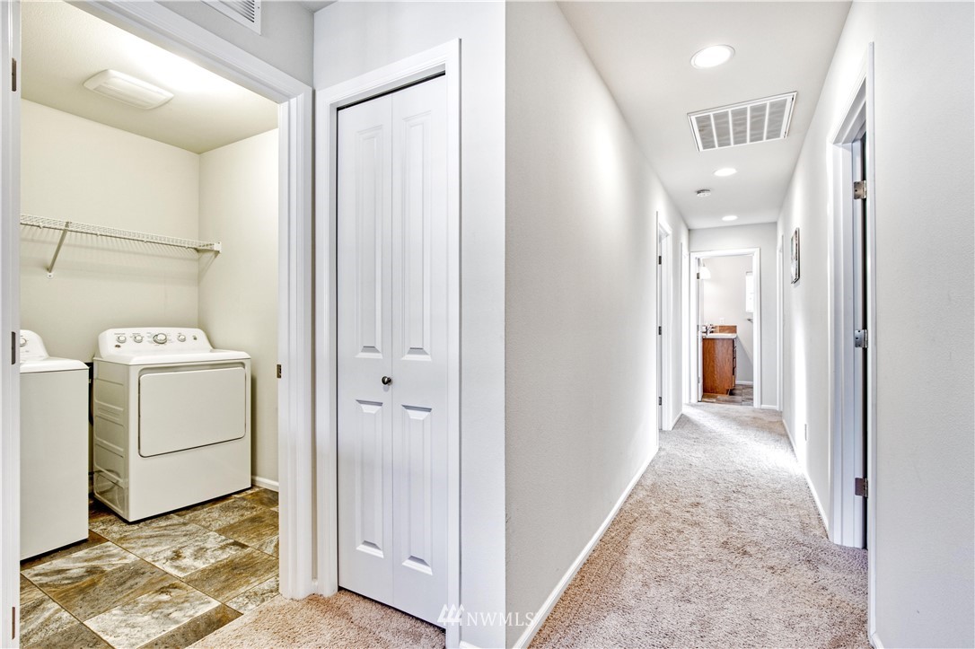 4866 East R Street Tacoma, WA 98404 - Photo 18 of 25 a view of a hallway with white cabinets