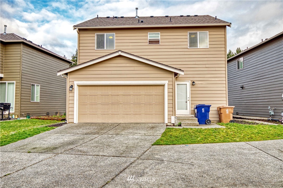 4866 East R Street Tacoma, WA 98404 - Photo 24 of 25 a front view of a house with a yard and garage