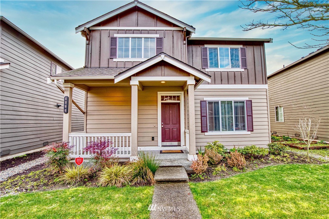 4866 East R Street Tacoma, WA 98404 - Photo 25 of 25 a front view of a house with garden