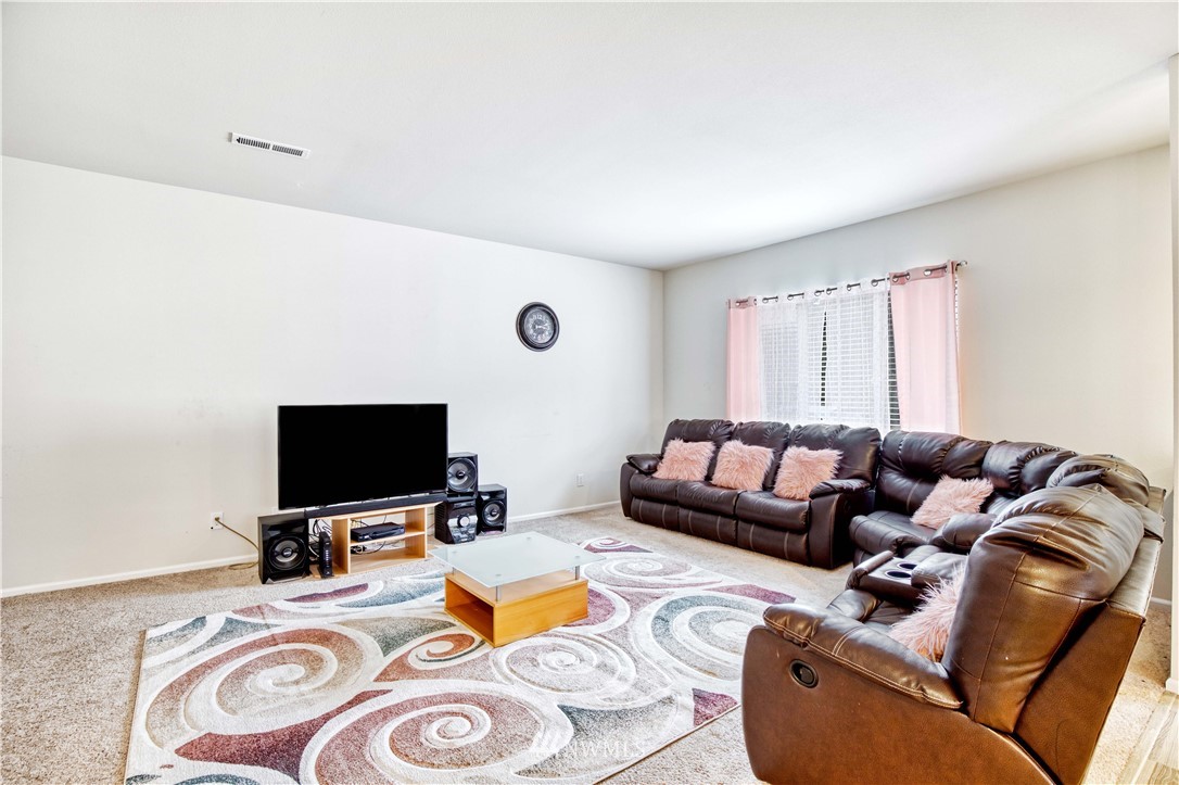4866 East R Street Tacoma, WA 98404 - Photo 5 of 25 a living room with furniture and a flat screen tv
