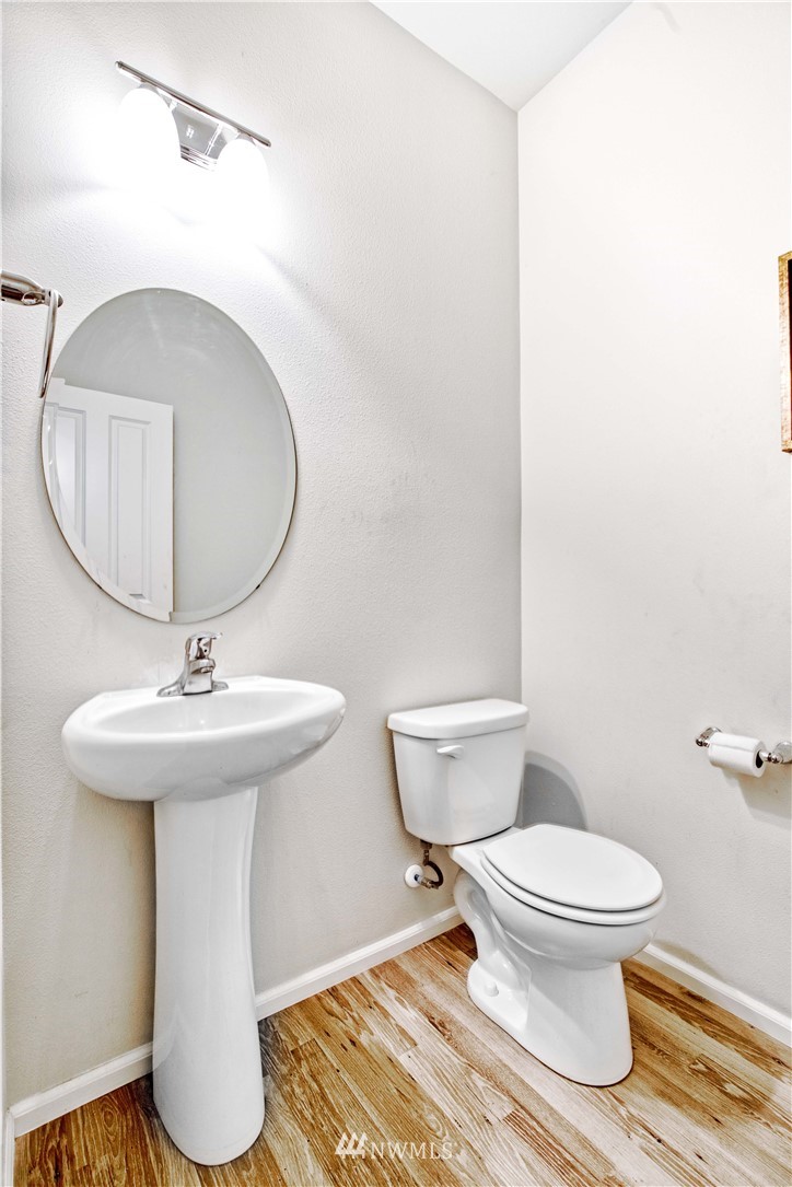 4866 East R Street Tacoma, WA 98404 - Photo 8 of 25 a bathroom with a toilet sink and mirror