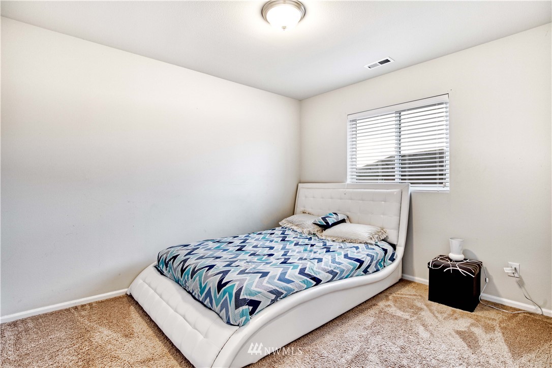 4866 East R Street Tacoma, WA 98404 - Photo 9 of 25 a bedroom with a bed and a window