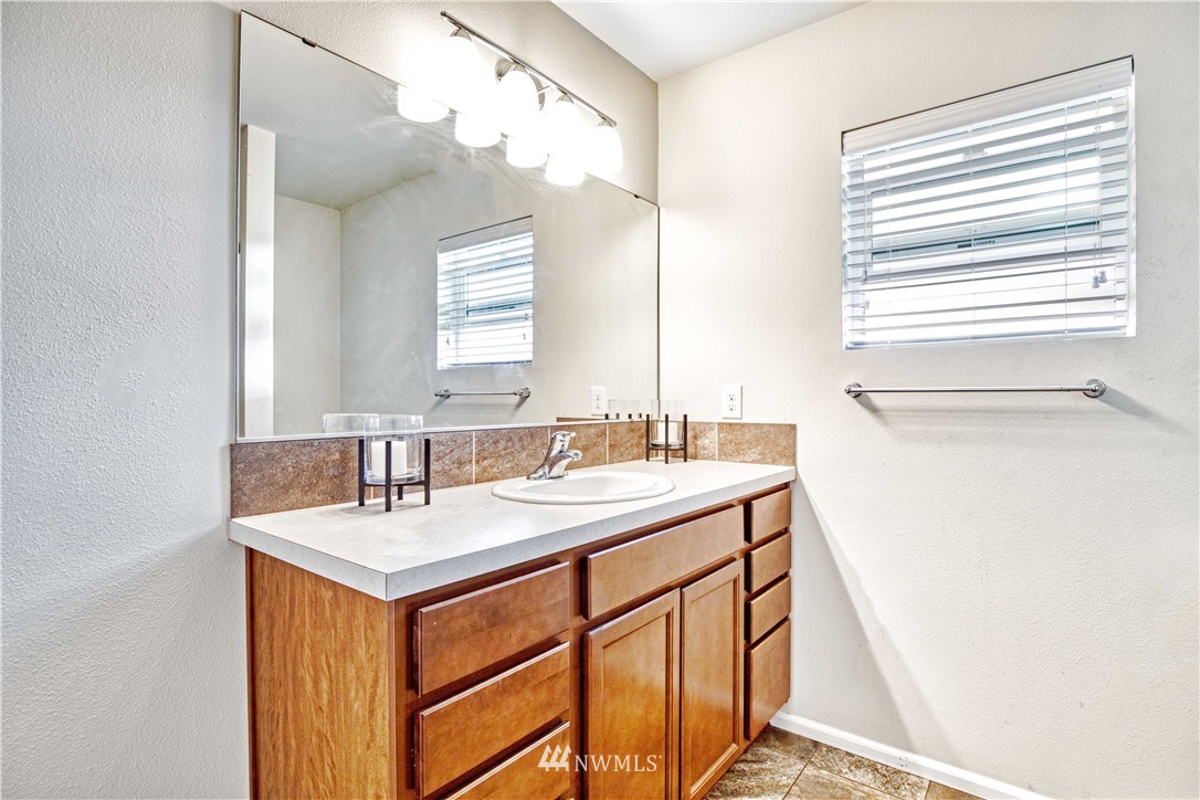 4866 East R Street Tacoma, WA 98404 - Photo 10 of 25 a bathroom with a sink and a mirror