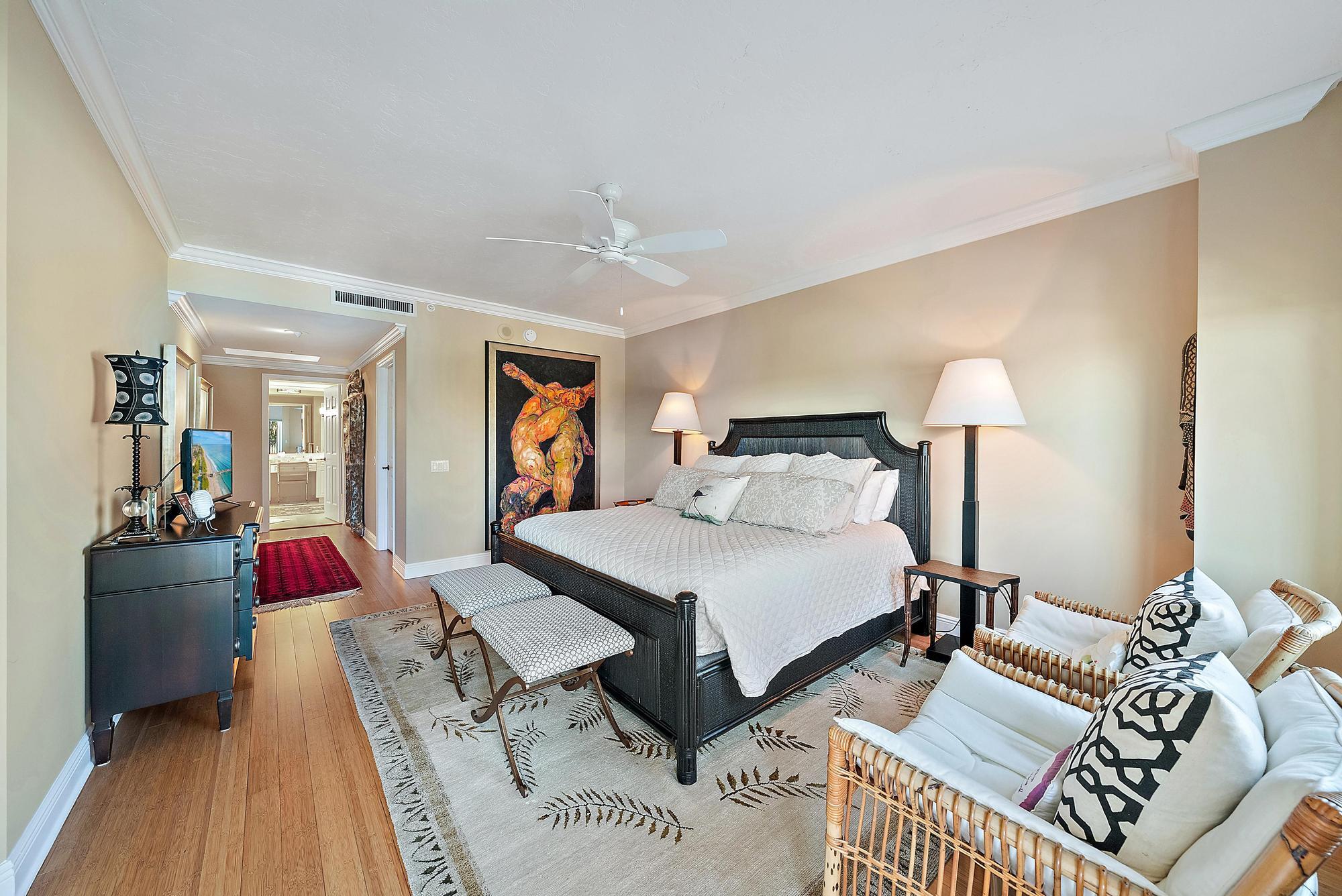 340 Highway 1, Unit 305 Jupiter, FL 33477 - Photo 11 of 26 a bedroom with a bed and wooden floor