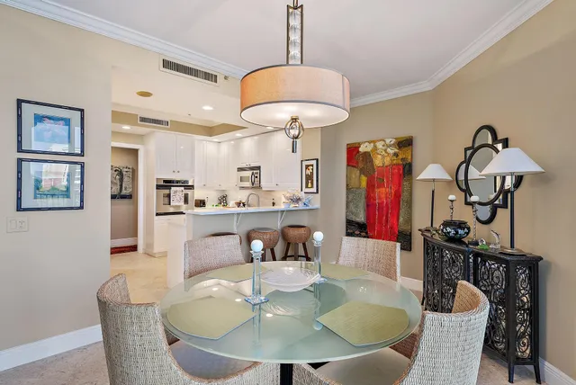 a dining room with furniture a chandelier and window