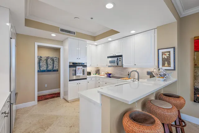 a kitchen with a sink cabinets and refrigerator
