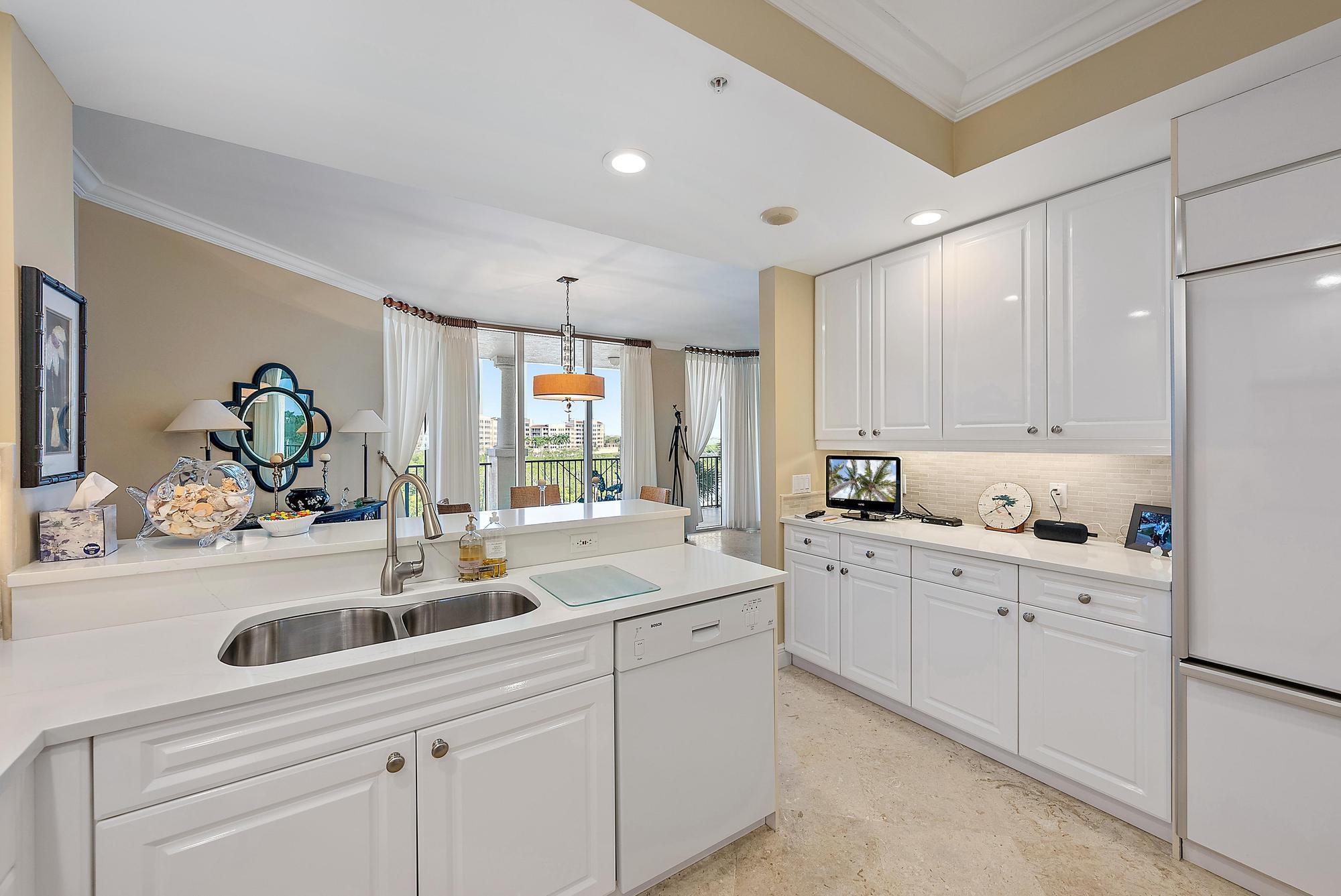 340 Highway 1, Unit 305 Jupiter, FL 33477 - Photo 9 of 26 a kitchen with white cabinets and sink