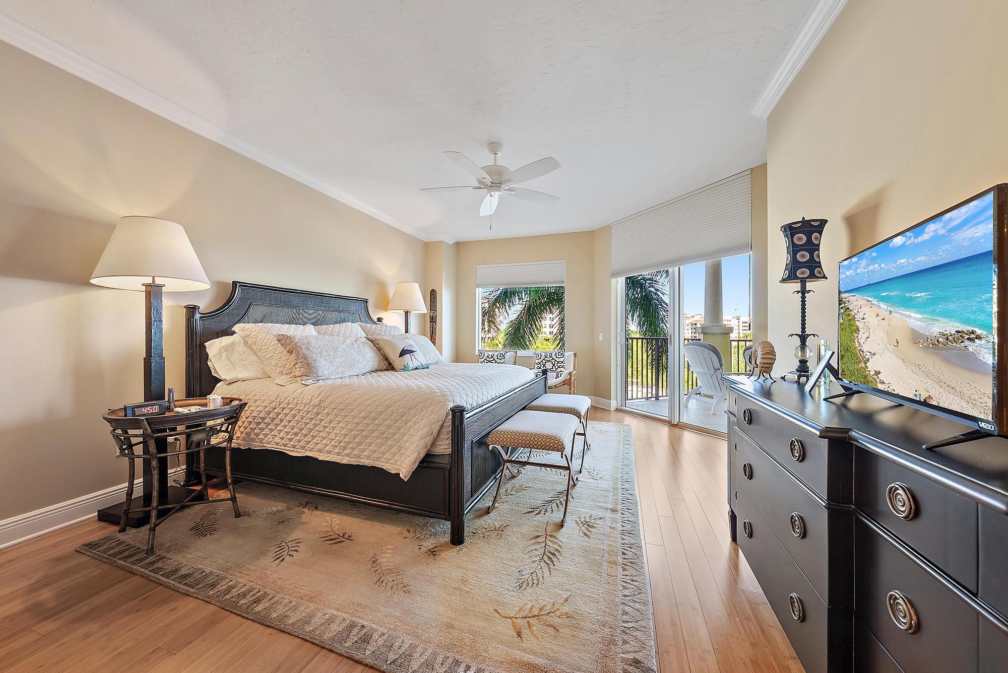 340 Highway 1, Unit 305 Jupiter, FL 33477 - Photo 10 of 26 a bedroom with a bed and a chandelier