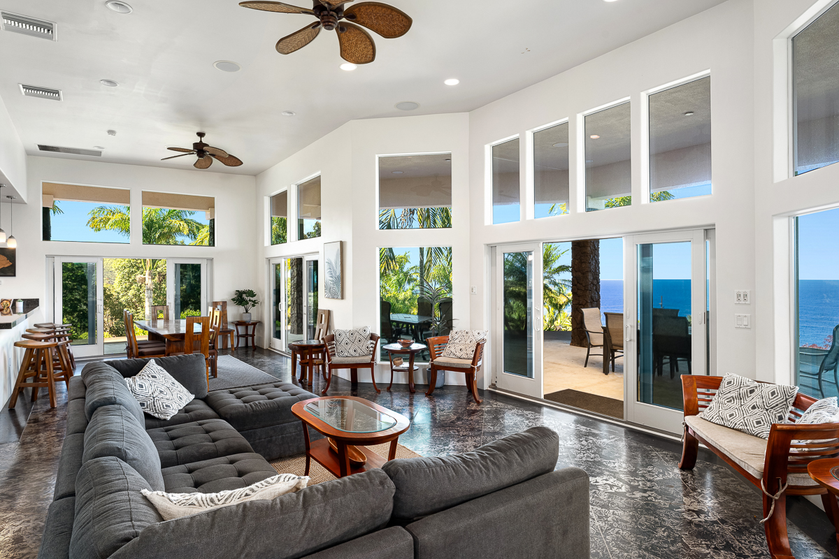 34-144 Kaihuiki Road Ninole, HI 96773 - Photo 11 of 25 a living room with furniture potted plant and large windows