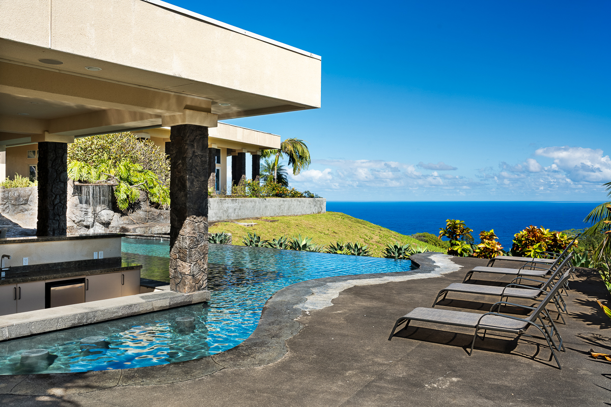 34-144 Kaihuiki Road Ninole, HI 96773 - Photo 7 of 25 a view of a patio with table and chairs under an umbrella