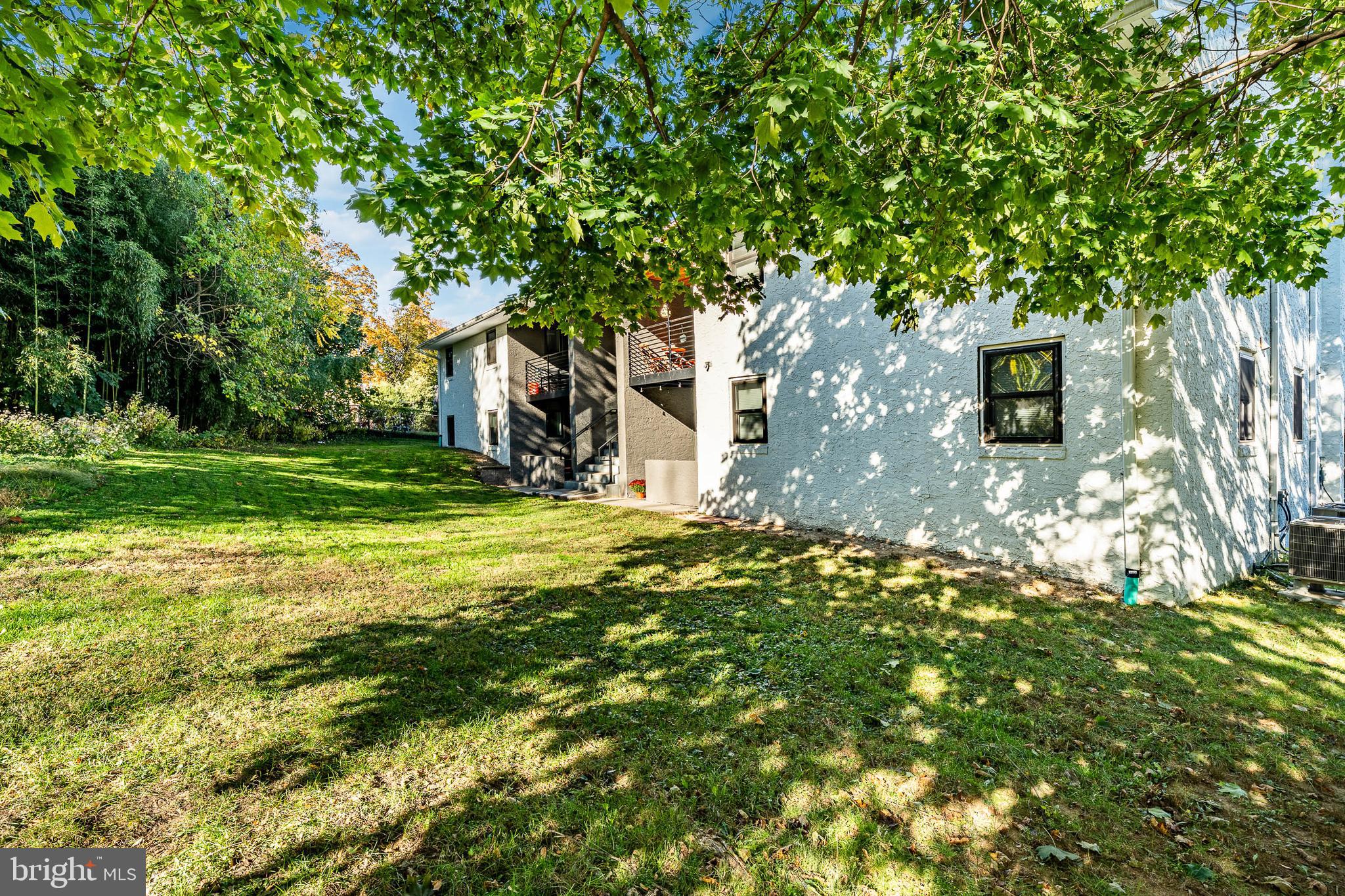 530 Washington Avenue, Unit 4 Phoenixville, PA 19460 - Photo 23 of 28 a backyard of a house with lots of green space and fountain
