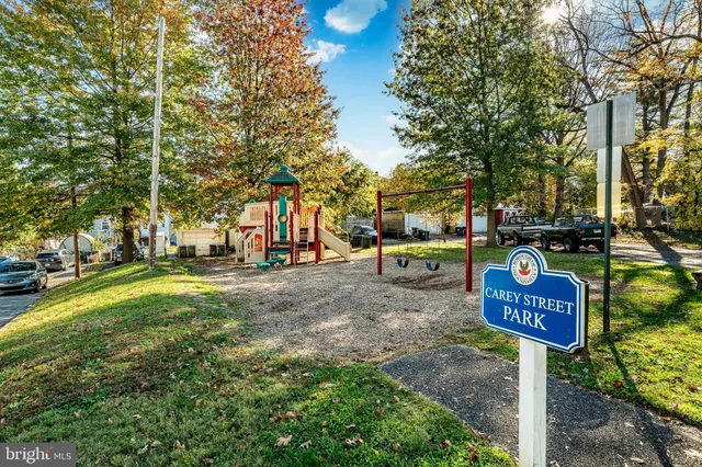 a street sign on a sidewalk next to a road