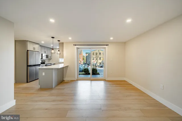 a view of kitchen with refrigerator and window
