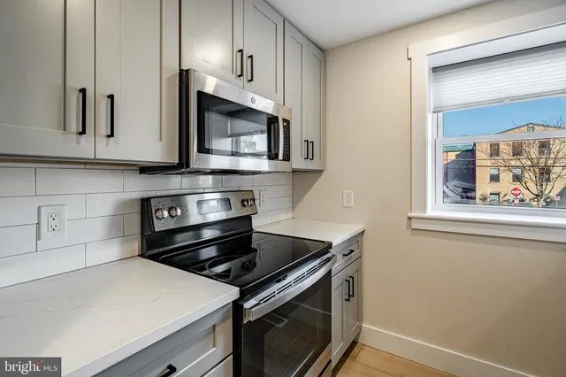 a kitchen with a stove microwave and sink