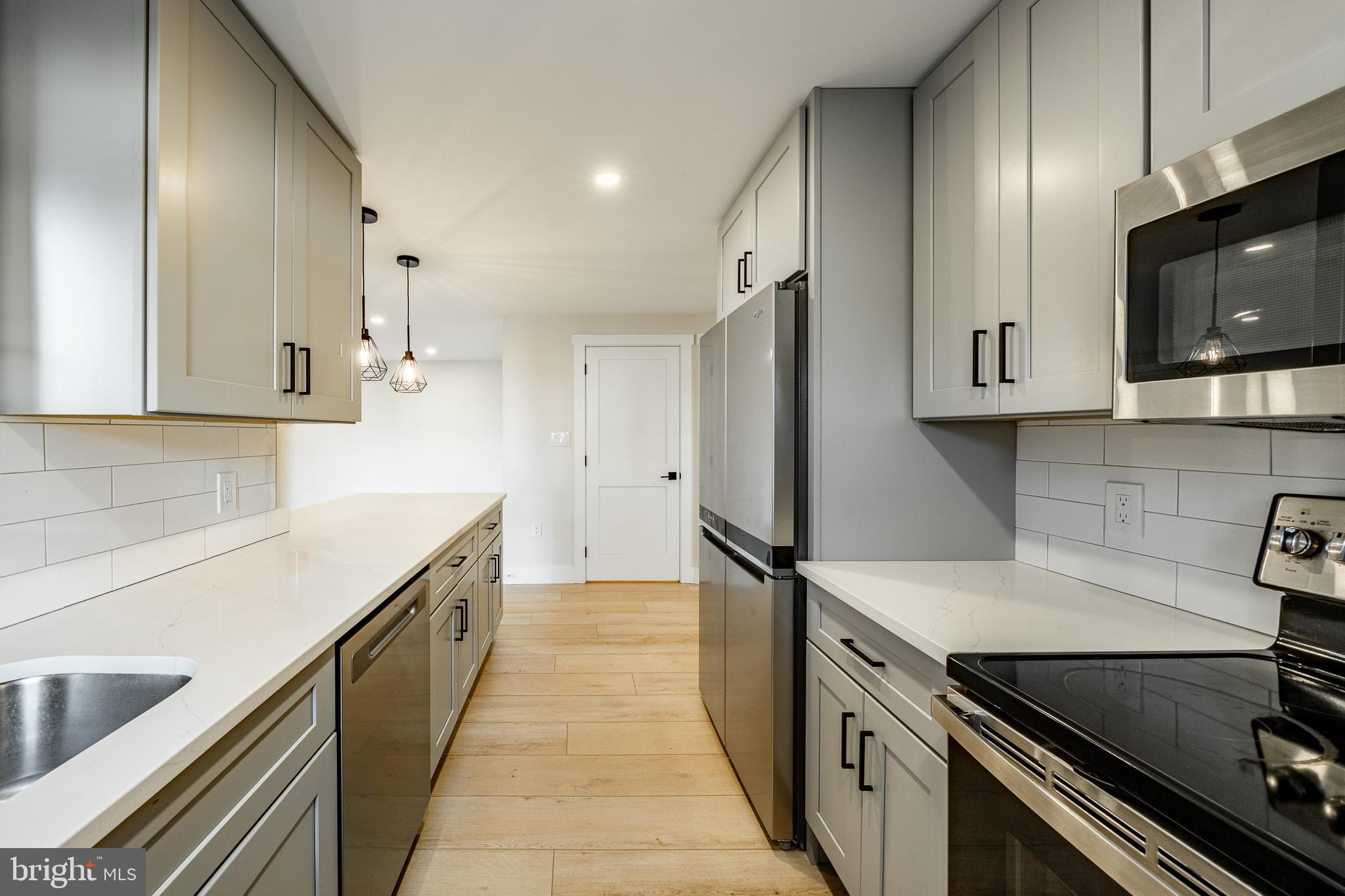530 Washington Avenue, Unit 4 Phoenixville, PA 19460 - Photo 9 of 28 a kitchen with stainless steel appliances a stove microwave and sink