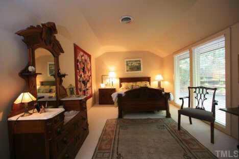 11900 Creedmoor Road Raleigh, NC 27614 - Photo 10 of 10 a bedroom with a bed and a couch