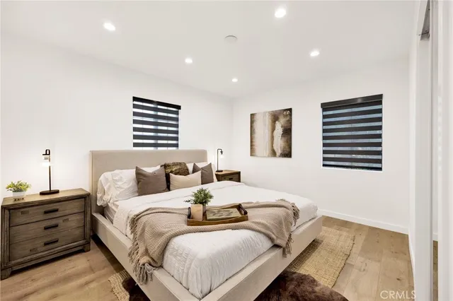 a bedroom with bed and a night stand