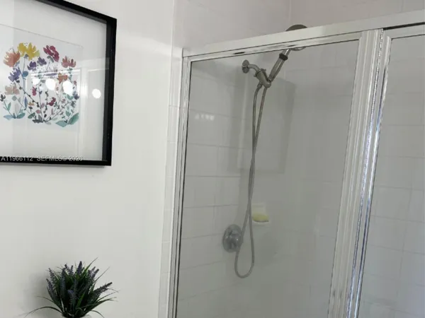 a bathroom with a shower and a shower