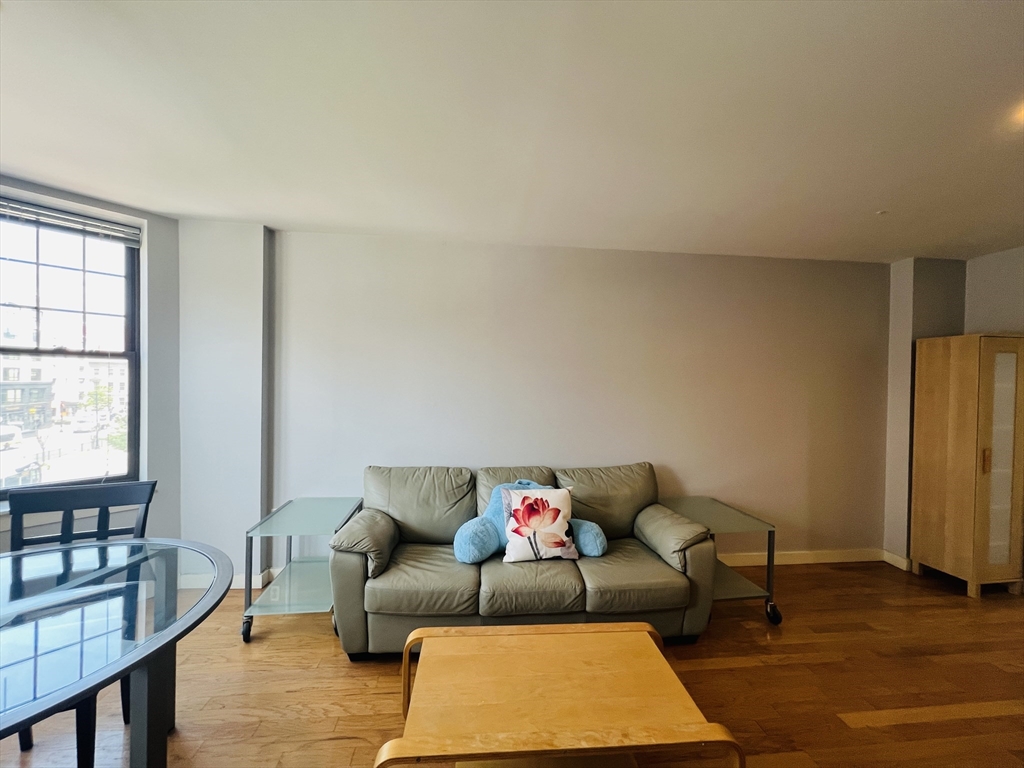 534 Commonwealth Avenue, Unit 3A Boston, MA 02215 - Photo 3 of 15 a living room with furniture and a rug