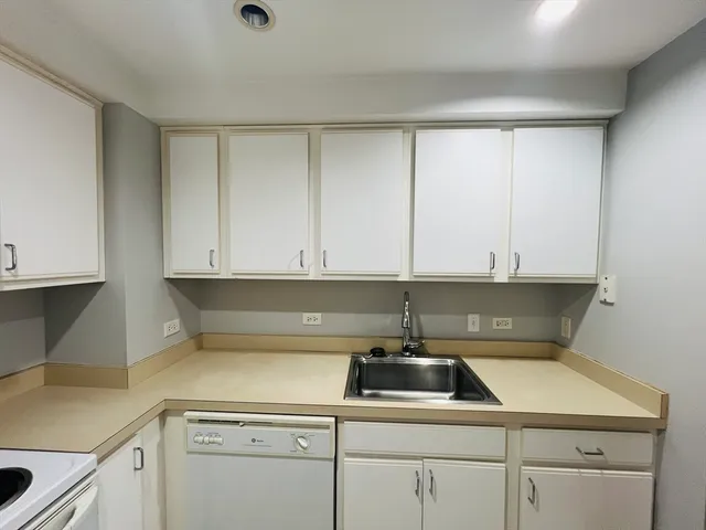 a kitchen with a sink cabinets and appliances
