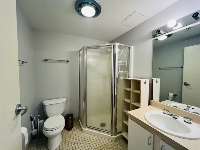 a bathroom with a sink toilet and shower
