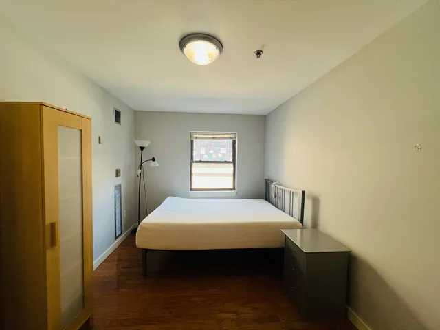 a bedroom with a bed and window