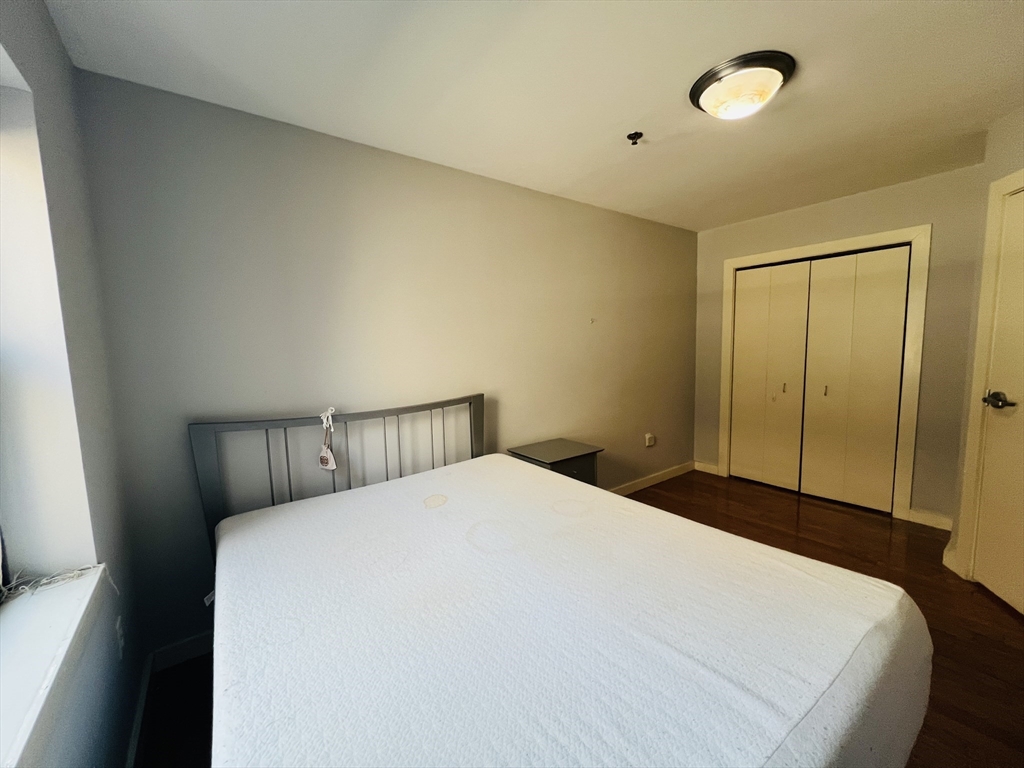 534 Commonwealth Avenue, Unit 3A Boston, MA 02215 - Photo 10 of 15 a bedroom with a bed and a mirror