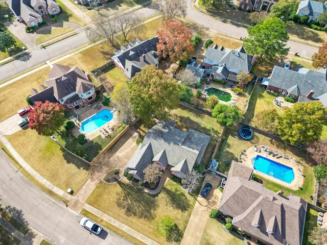 an aerial view of a house with a swimming pool