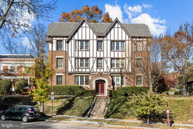 a view of a car parked in front of a brick house